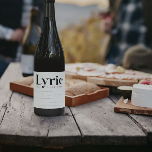 Bouteille de vin de la marque Lyric Wines sur une table de pique-nique.
